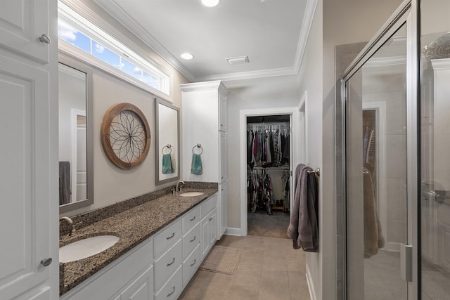 318 Oconee Dr, Midland City, AL 36350 - full bath featuring a shower stall, crown molding, double vanity, a walk in closet, and baseboards