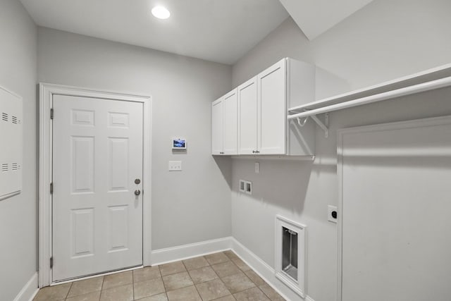 washroom featuring cabinets, light tile patterned flooring, washer hookup, and hookup for an electric dryer