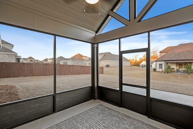 unfurnished sunroom with vaulted ceiling