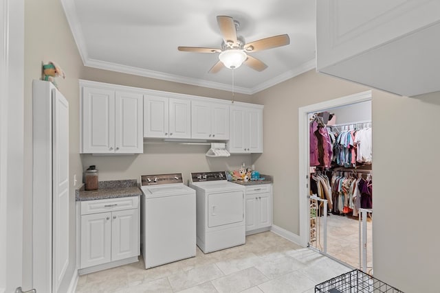 washroom with washing machine and clothes dryer, cabinets, ceiling fan, light tile patterned floors, and crown molding