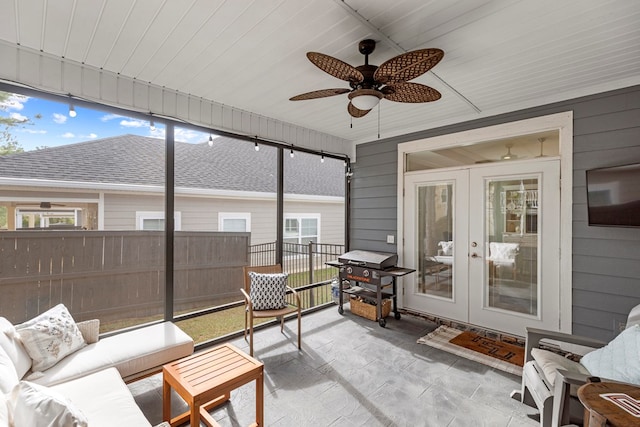 sunroom with ceiling fan and french doors