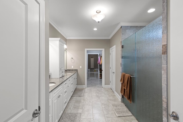 bathroom featuring tile patterned flooring, crown molding, vanity, and a shower with shower door