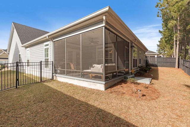 rear view of property featuring a lawn and a sunroom