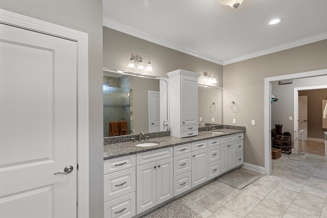 bathroom featuring ornamental molding and vanity