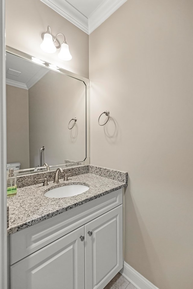 bathroom with toilet, tile patterned flooring, crown molding, and vanity