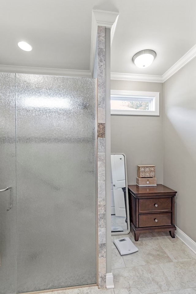 bathroom with a shower with door and crown molding