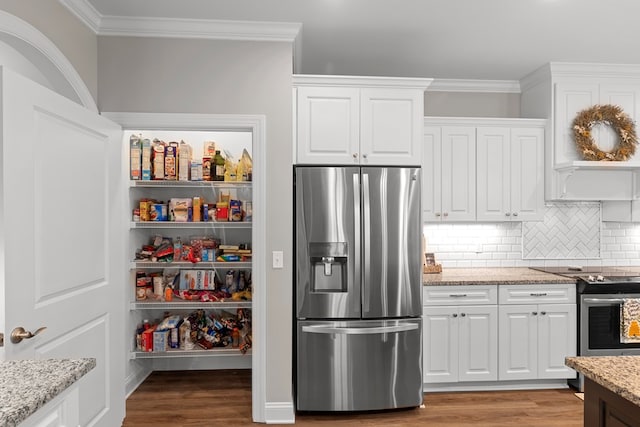 kitchen with stainless steel appliances, decorative backsplash, white cabinetry, and light stone counters