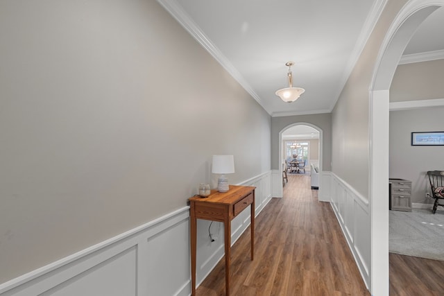 hallway with dark wood-type flooring and crown molding