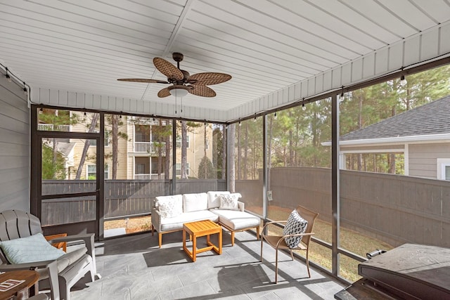 sunroom featuring ceiling fan