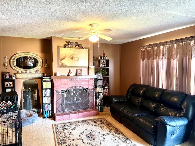 carpeted living room featuring a textured ceiling, a brick fireplace, and a ceiling fan