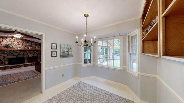 2104 Centenial Dr, Dothan, AL 36303 - unfurnished dining area with a chandelier, a fireplace, a ceiling fan, a textured ceiling, and crown molding