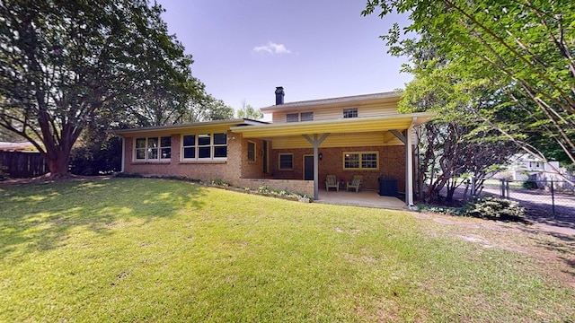 2104 Centenial Dr, Dothan, AL 36303 - rear view of property featuring a chimney, brick siding, and a patio area
