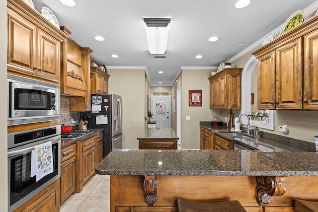 kitchen with a breakfast bar, sink, kitchen peninsula, and stainless steel appliances