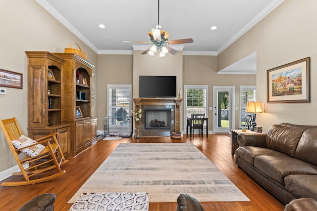 living room with ceiling fan, hardwood / wood-style floors, and ornamental molding