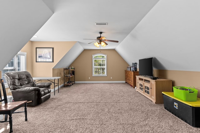 interior space with carpet, ceiling fan, and lofted ceiling