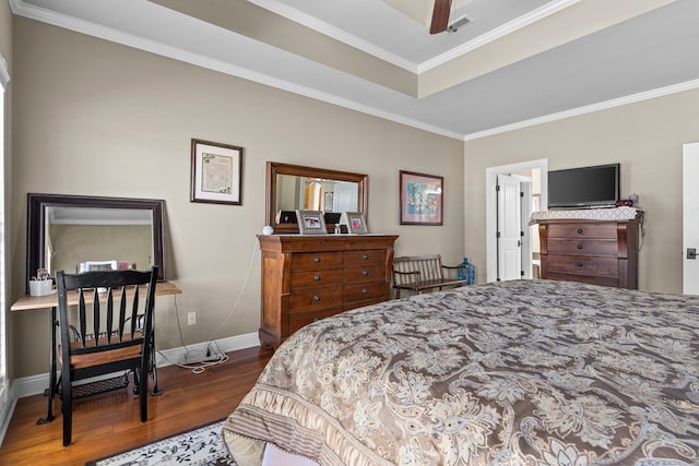 bedroom featuring a tray ceiling, crown molding, ceiling fan, and dark hardwood / wood-style floors