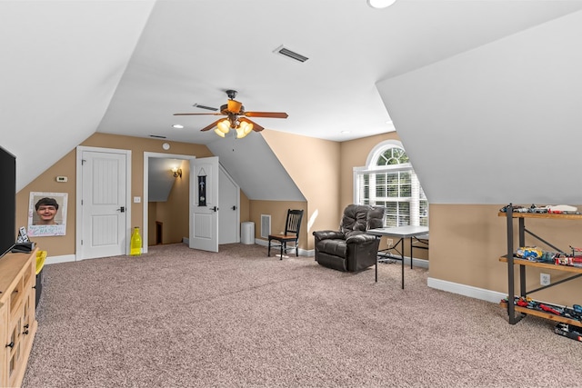 living area featuring carpet, ceiling fan, and vaulted ceiling