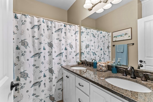 bathroom featuring a shower with curtain and vanity