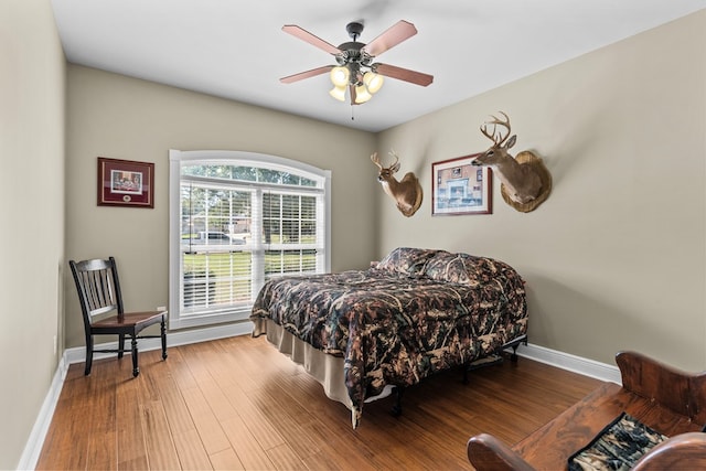 bedroom featuring hardwood / wood-style flooring and ceiling fan