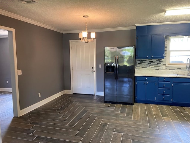 kitchen featuring stainless steel refrigerator with ice dispenser, a textured ceiling, backsplash, and sink