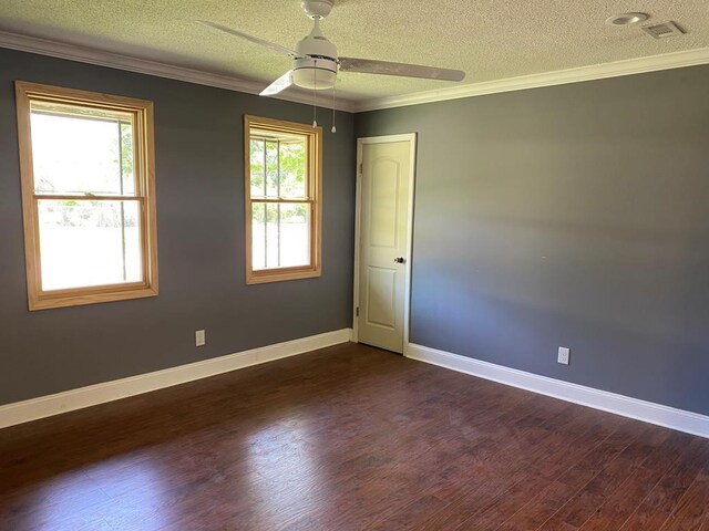 spare room with dark hardwood / wood-style flooring, a healthy amount of sunlight, and a textured ceiling