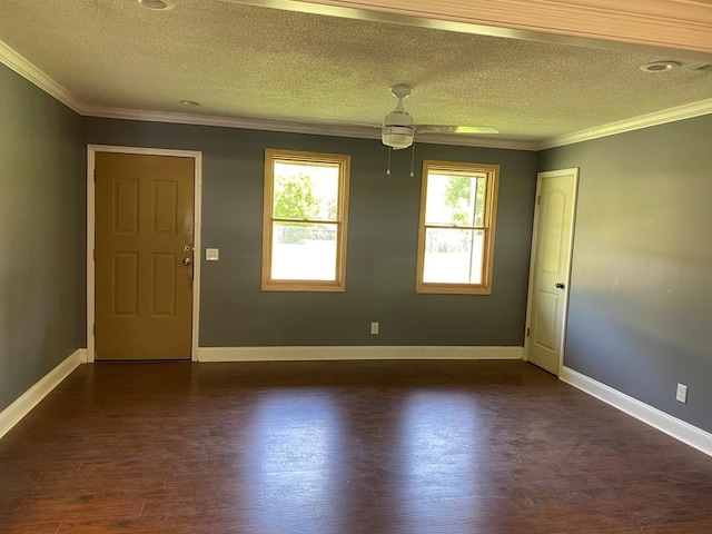 empty room with a textured ceiling, crown molding, ceiling fan, and dark hardwood / wood-style floors