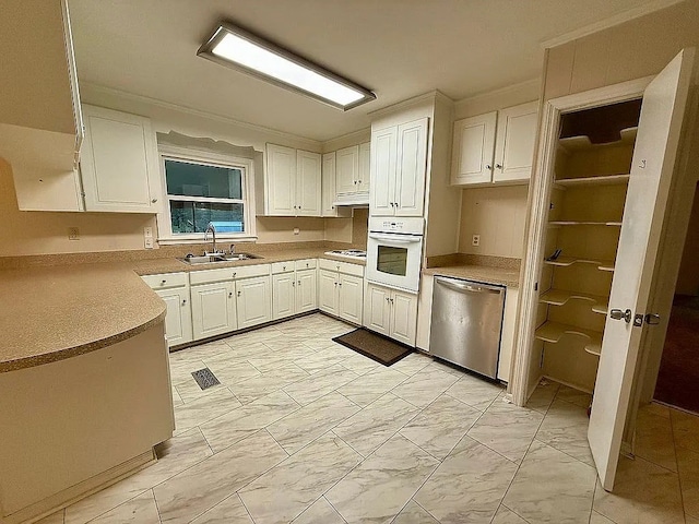 kitchen featuring white cabinetry, white appliances, and sink