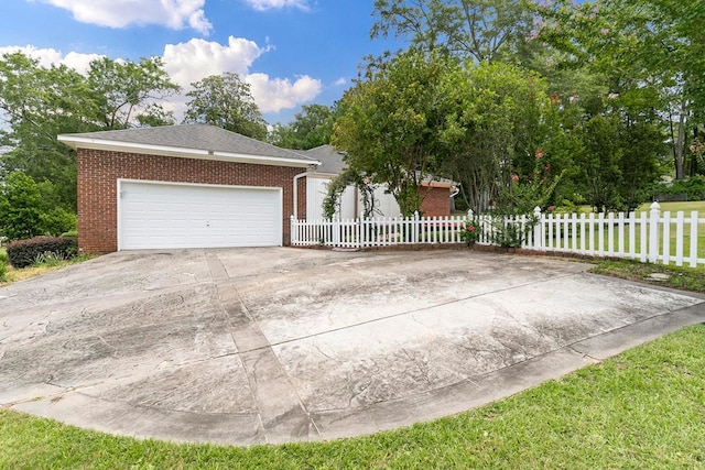 1104 Strathmore Ave, Dothan, AL 36303 - view of front of house with brick siding, driveway, an attached garage, and a fenced front yard