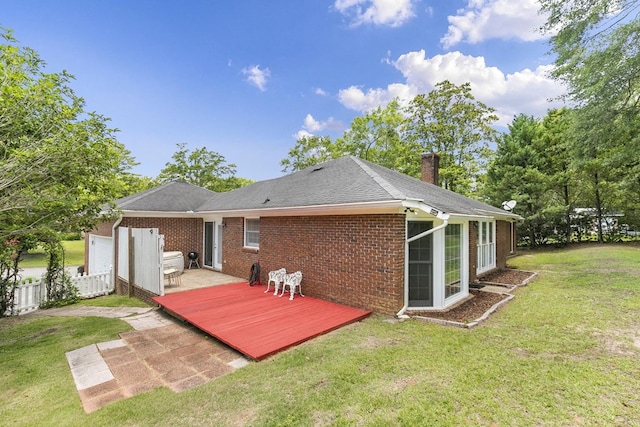 1104 Strathmore Ave, Dothan, AL 36303 - rear view of house with a wooden deck, brick siding, a chimney, and a lawn
