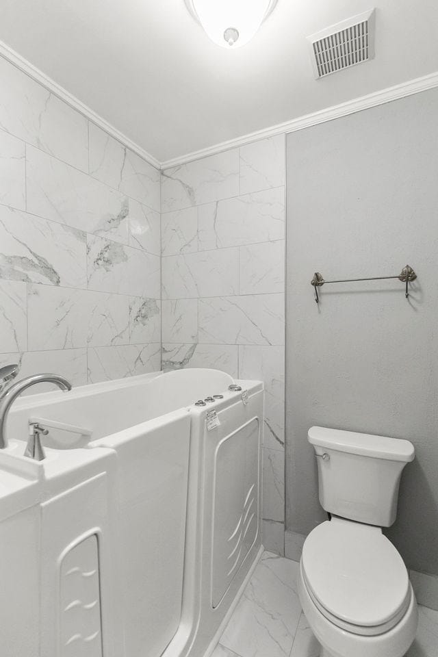 1104 Strathmore Ave, Dothan, AL 36303 - full bathroom featuring marble look tiles, a bath, and crown molding