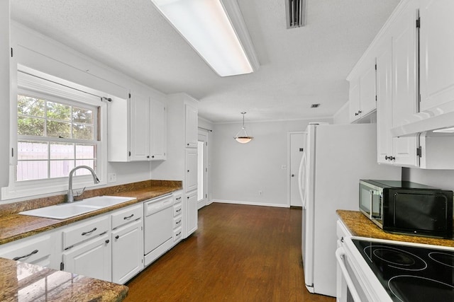 1104 Strathmore Ave, Dothan, AL 36303 - kitchen featuring white appliances, dark wood-type flooring, white cabinetry, and pendant lighting