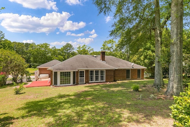 1104 Strathmore Ave, Dothan, AL 36303 - back of property with a wooden deck, brick siding, and a chimney