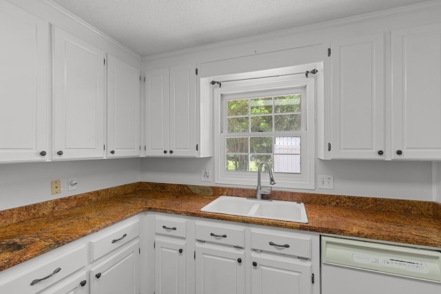 1104 Strathmore Ave, Dothan, AL 36303 - kitchen with white dishwasher, white cabinets, and a textured ceiling
