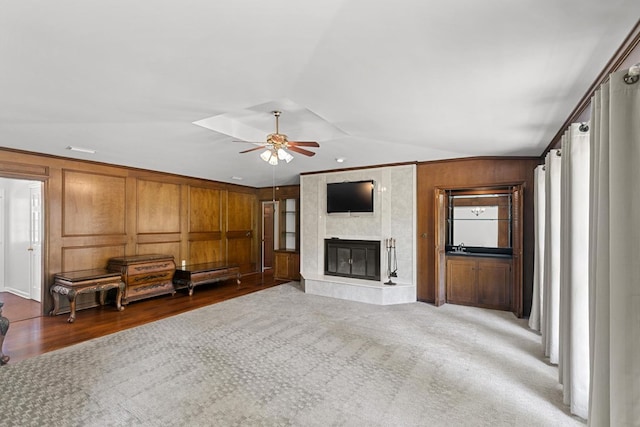 1104 Strathmore Ave, Dothan, AL 36303 - unfurnished living room with ceiling fan, a high end fireplace, vaulted ceiling, wood finished floors, and wood walls