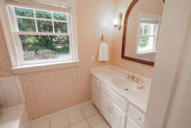 bathroom with tile patterned flooring, vanity, and a healthy amount of sunlight