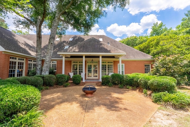 view of front of home featuring french doors and a fire pit