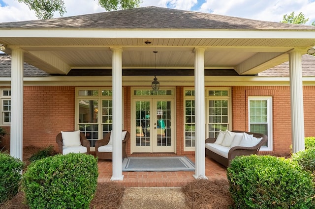 entrance to property featuring a porch and french doors