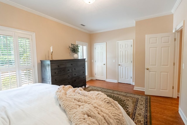 bedroom featuring wood-type flooring and ornamental molding