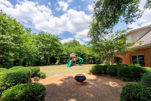 view of jungle gym featuring an outdoor fire pit