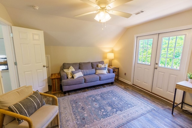 living room with ceiling fan, dark hardwood / wood-style flooring, and vaulted ceiling