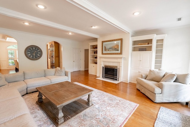 living room featuring light hardwood / wood-style floors and ornamental molding