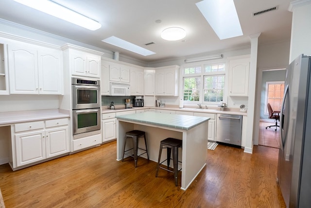 kitchen featuring a center island, white cabinets, and stainless steel appliances