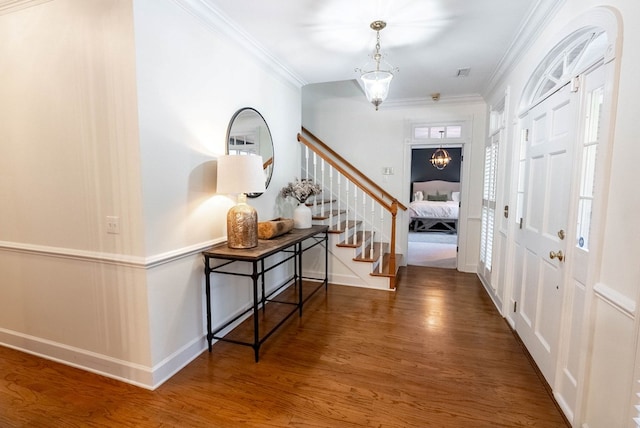 entryway featuring dark hardwood / wood-style floors and ornamental molding