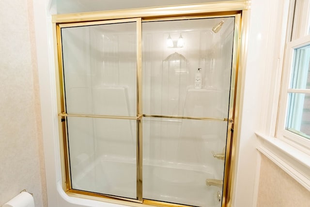 bathroom with a shower with door