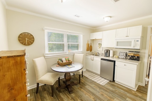 kitchen featuring ornamental molding, sink, wood-type flooring, dishwasher, and white cabinetry