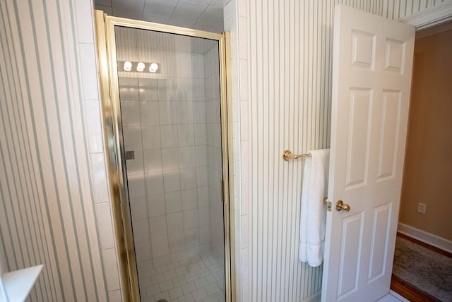 bathroom with a shower with door