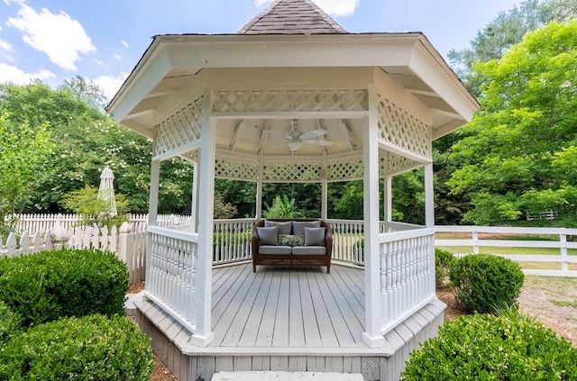 wooden terrace featuring a gazebo and ceiling fan