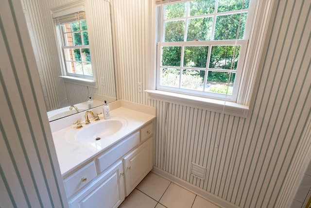 bathroom with tile patterned flooring, vanity, and a wealth of natural light