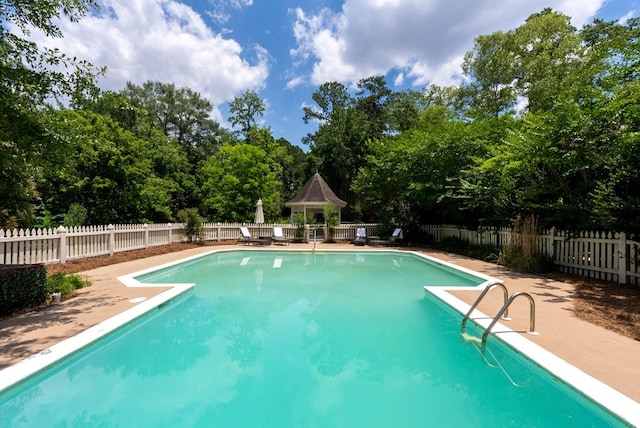 view of swimming pool with a gazebo and a patio area