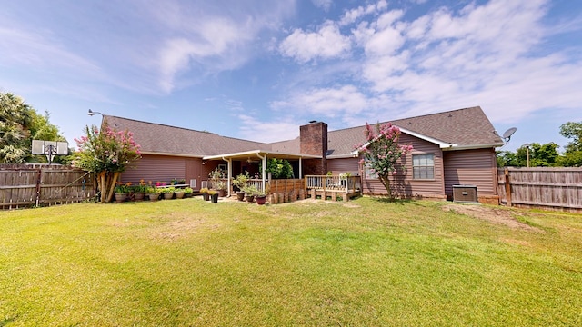 103 Yorkshire St, Dothan, AL 36305 - back of house with a fenced backyard, a chimney, a deck, and roof with shingles